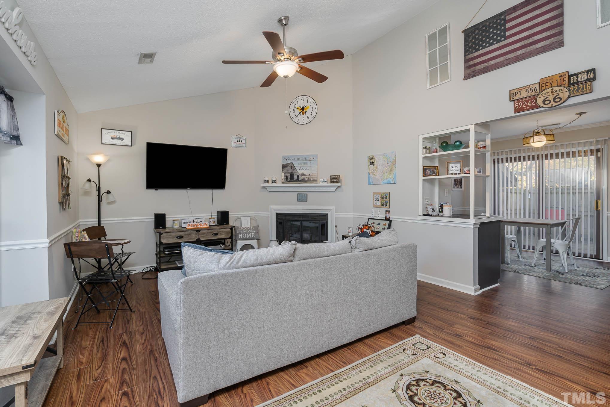 4701 Courtside Place Raleigh, NC 27604 - Photo 2 of 30 a living room with furniture a fireplace and a flat screen tv