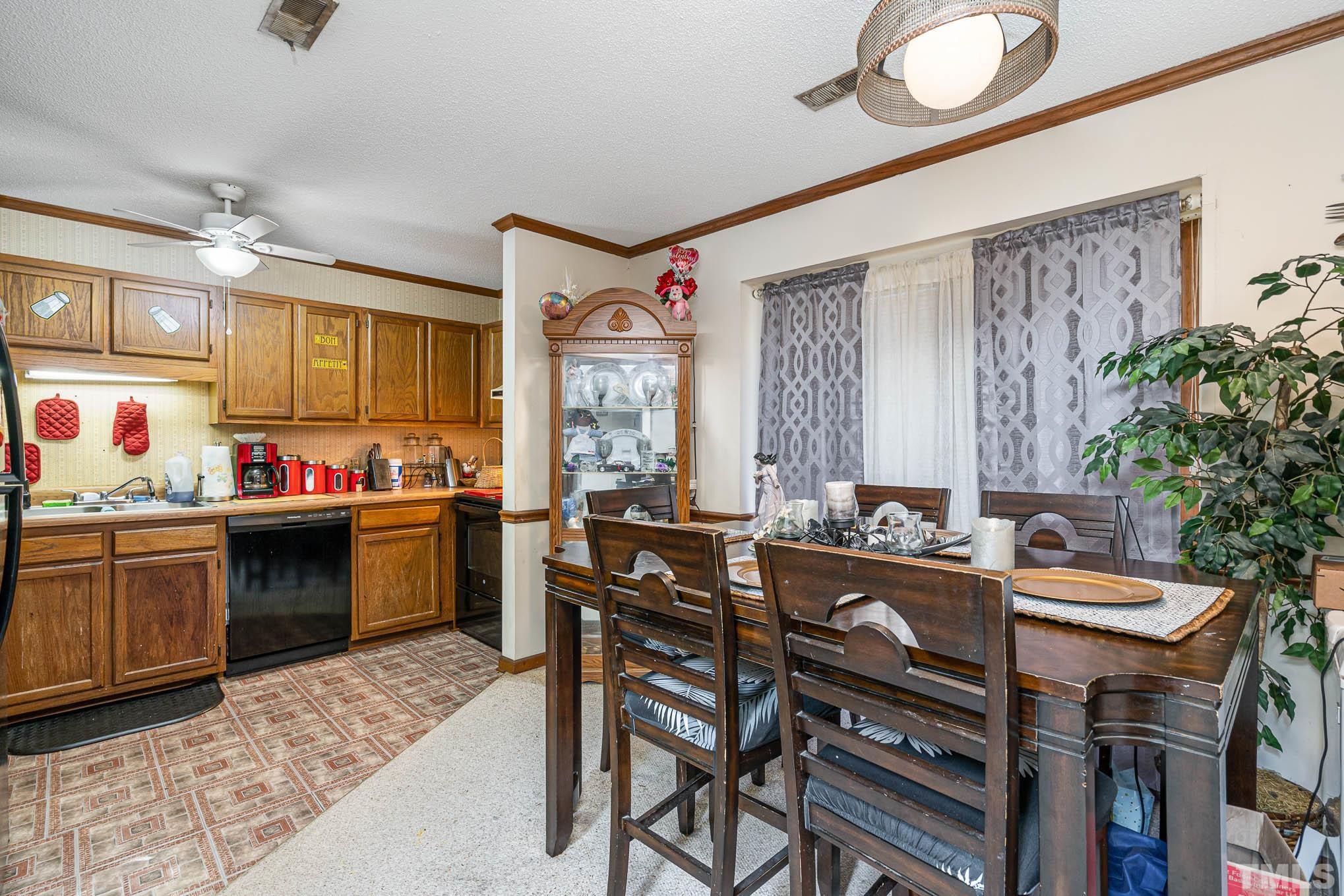 4701 Courtside Place Raleigh, NC 27604 - Photo 21 of 30 a kitchen with a table chairs stove and cabinets