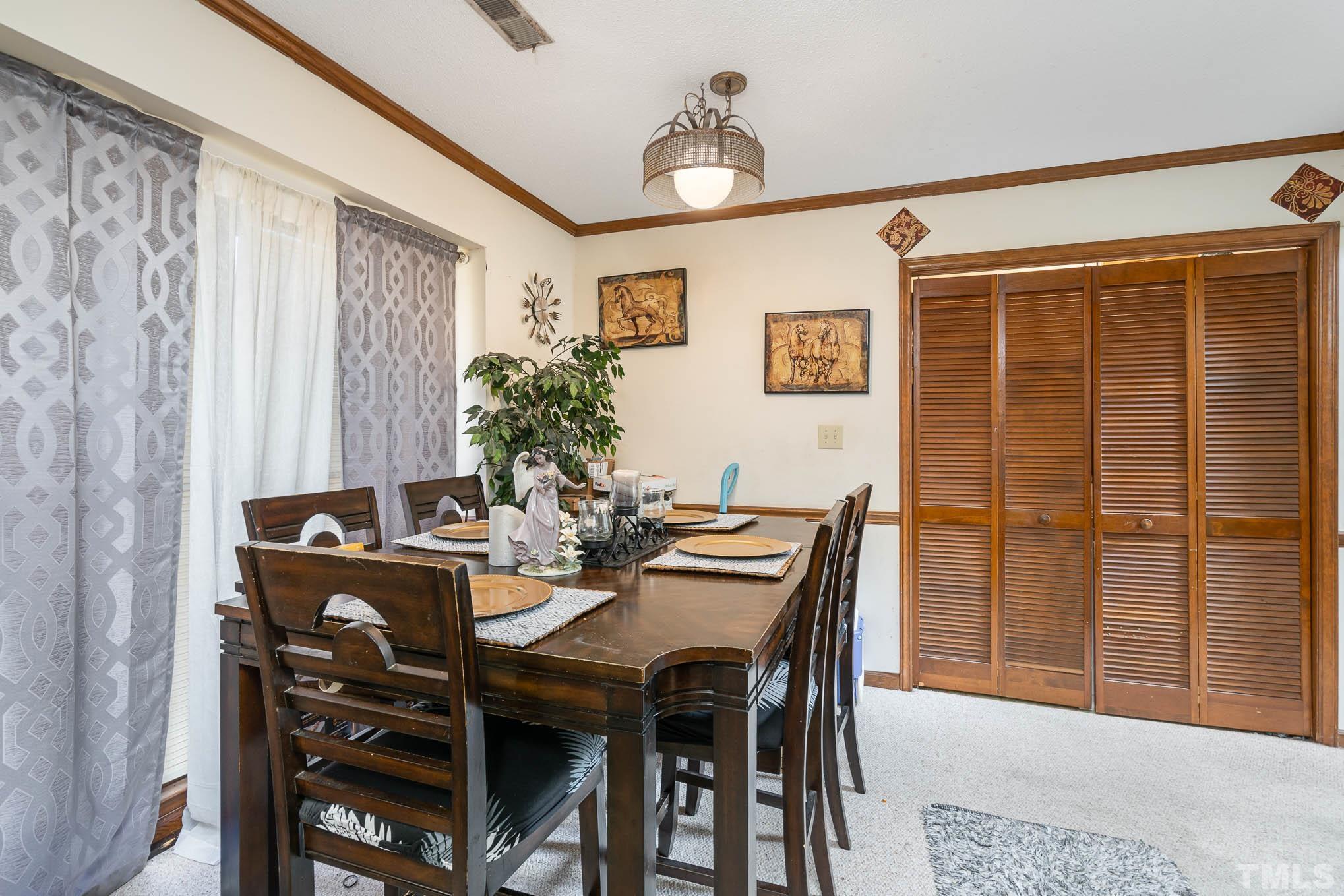 4701 Courtside Place Raleigh, NC 27604 - Photo 22 of 30 a view of a dining room with furniture and chandelier