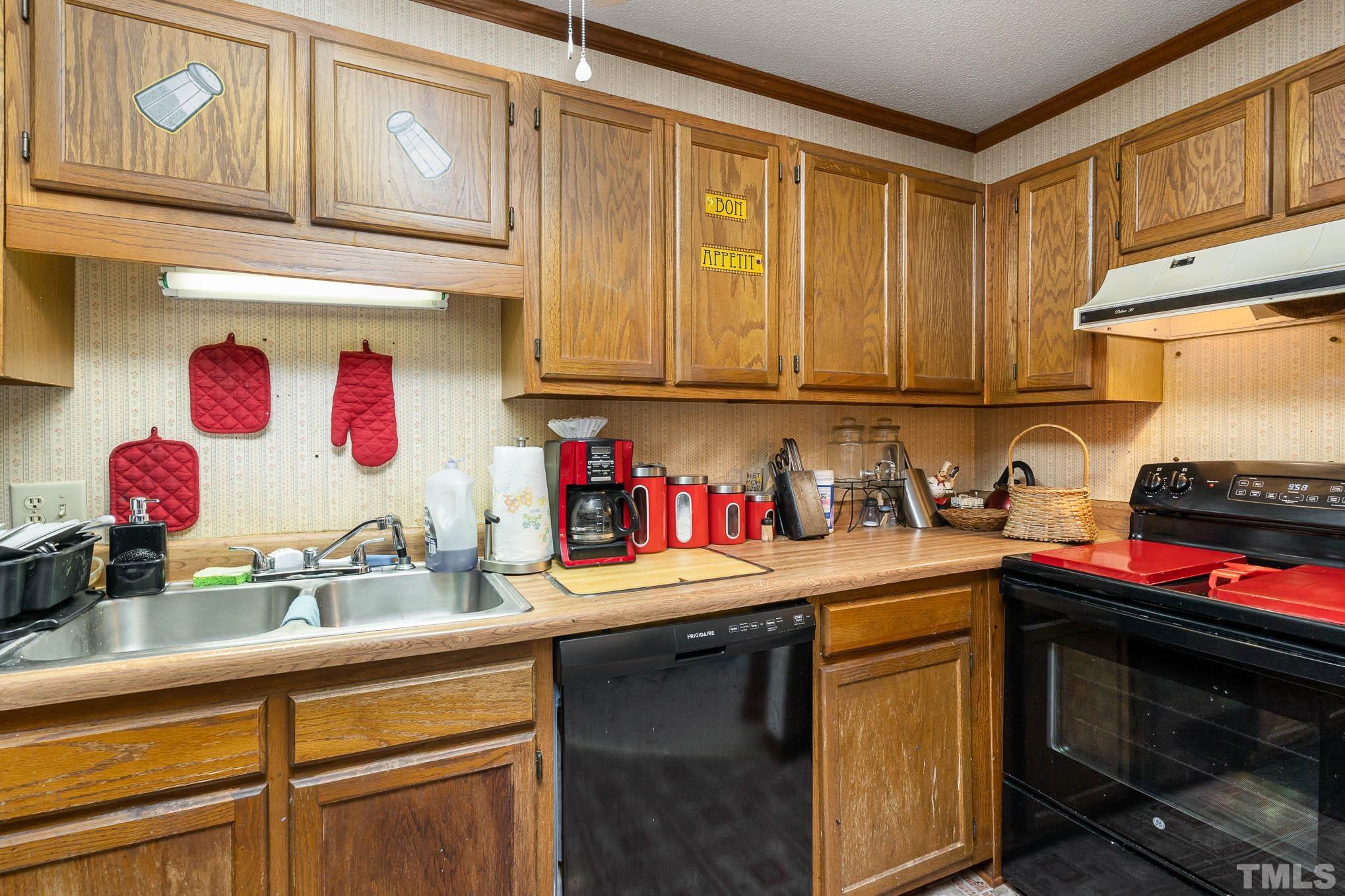 4701 Courtside Place Raleigh, NC 27604 - Photo 23 of 30 a kitchen with stainless steel appliances granite countertop a sink stove and cabinets