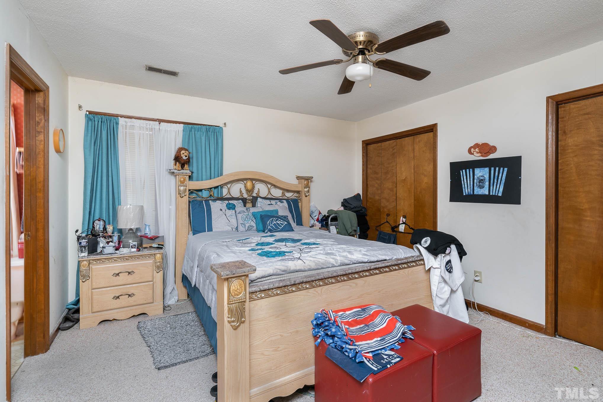 4701 Courtside Place Raleigh, NC 27604 - Photo 26 of 30 a bedroom with a bed and a chandelier