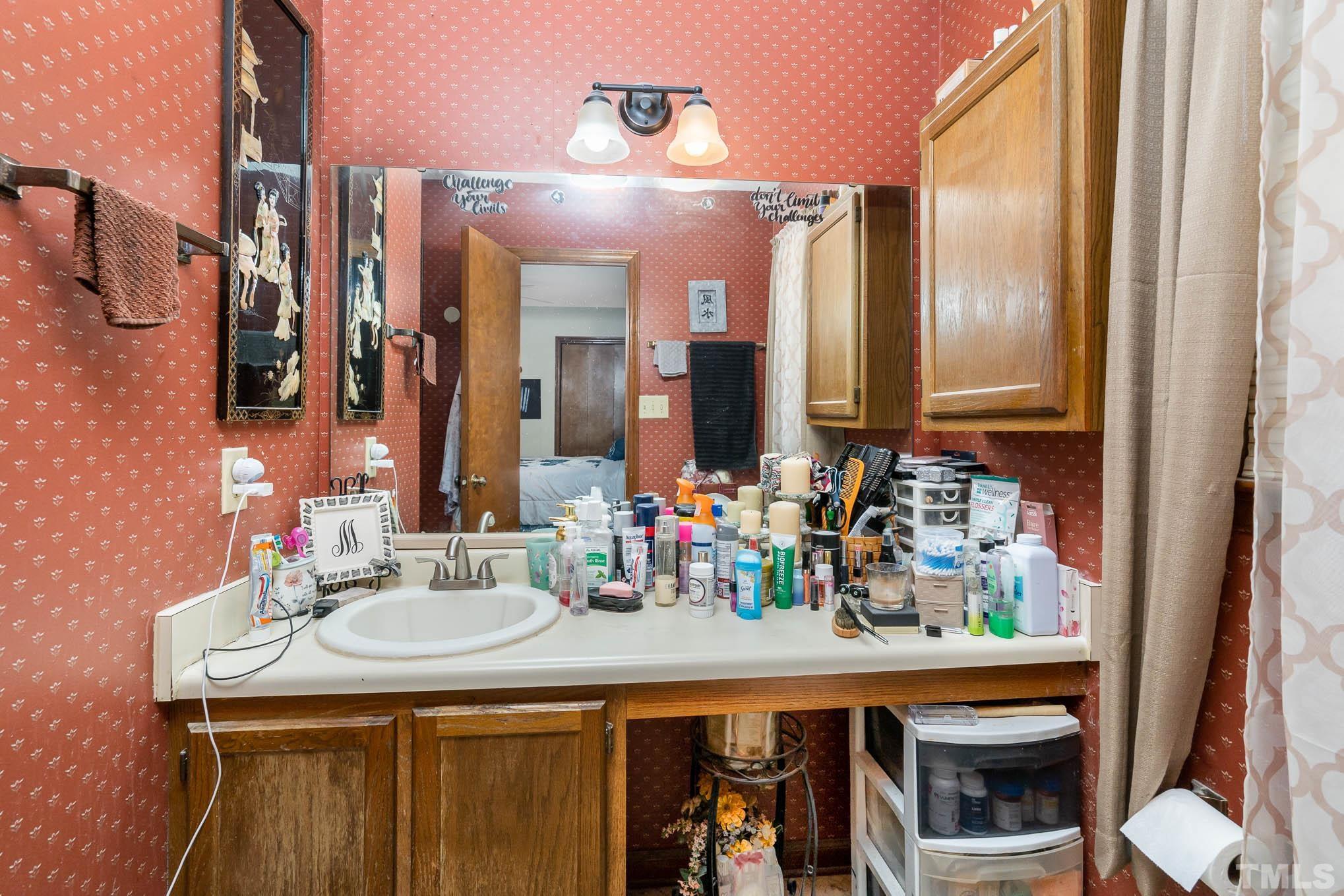 4701 Courtside Place Raleigh, NC 27604 - Photo 27 of 30 a bathroom with a sink double vanity and a mirror