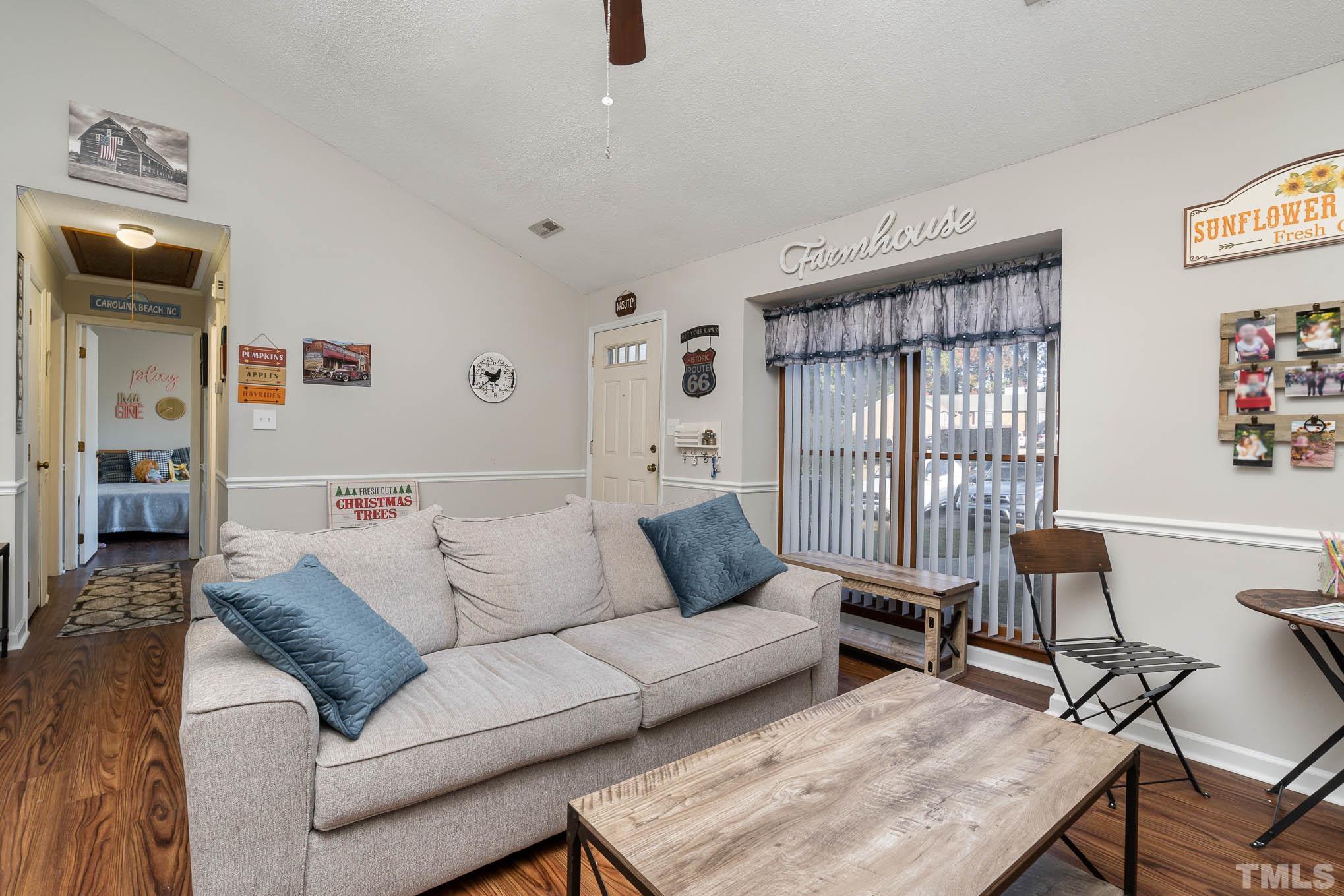 4701 Courtside Place Raleigh, NC 27604 - Photo 3 of 30 a living room with furniture and a wooden floor