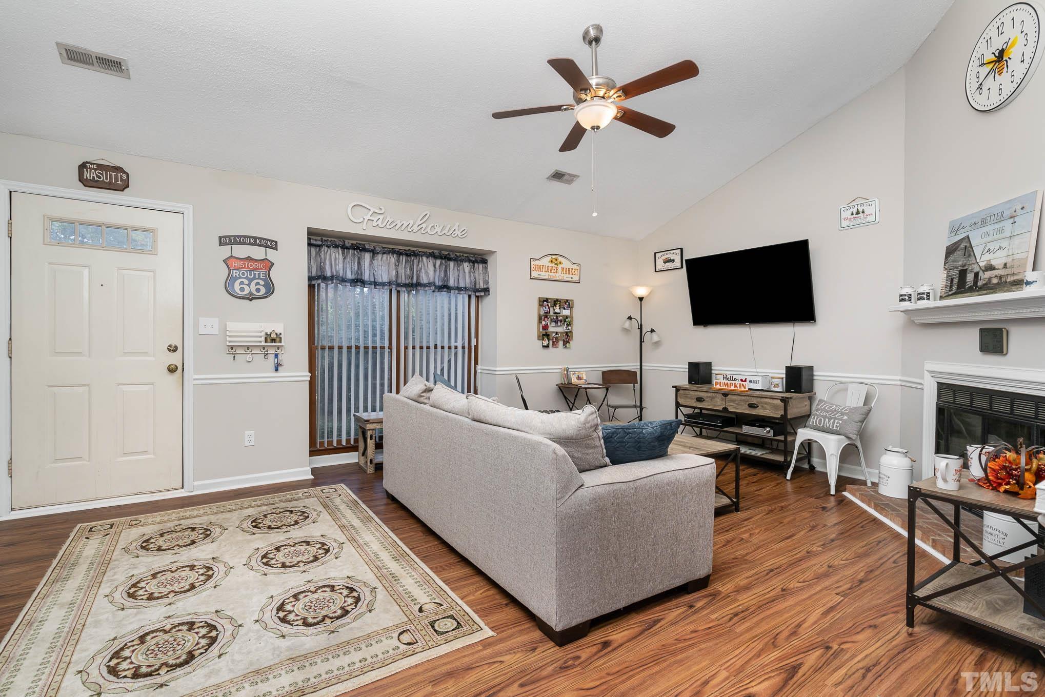 4701 Courtside Place Raleigh, NC 27604 - Photo 5 of 30 a living room with furniture and a flat screen tv