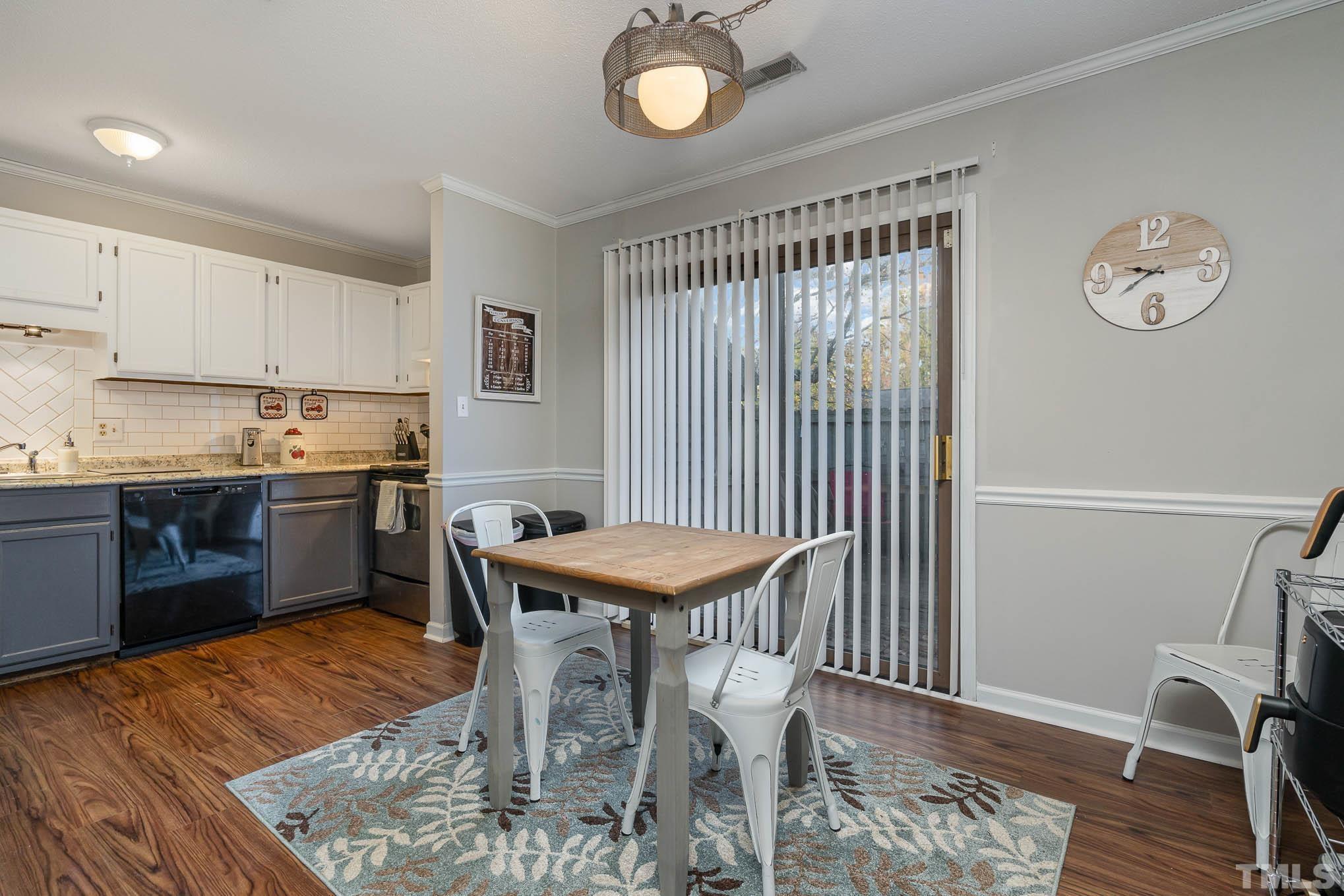 4701 Courtside Place Raleigh, NC 27604 - Photo 6 of 30 a kitchen with granite countertop a stove a sink and a refrigerator