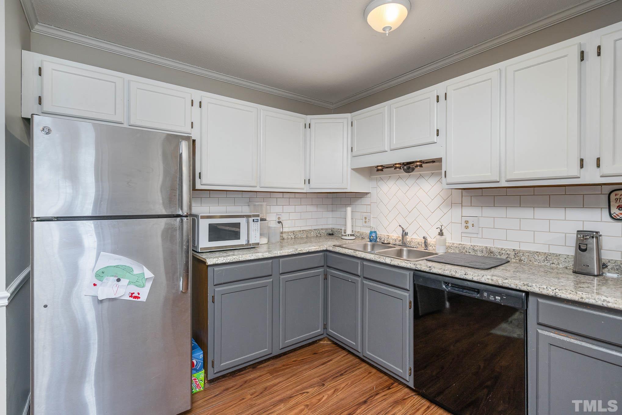 4701 Courtside Place Raleigh, NC 27604 - Photo 8 of 30 a kitchen with stainless steel appliances granite countertop a sink stove and refrigerator