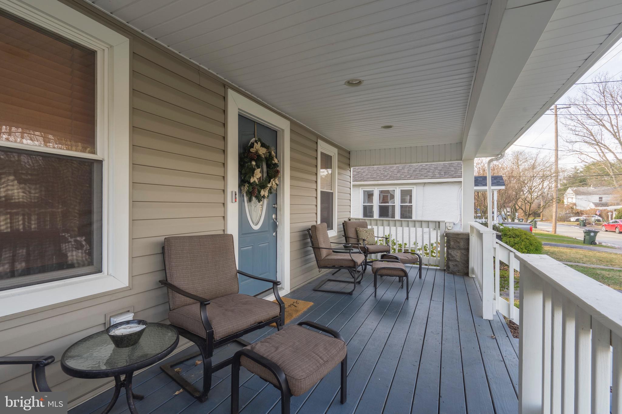 208 Willow Road Wallingford, PA 19086 - Photo 5 of 39 a balcony with wooden floor and outdoor seating