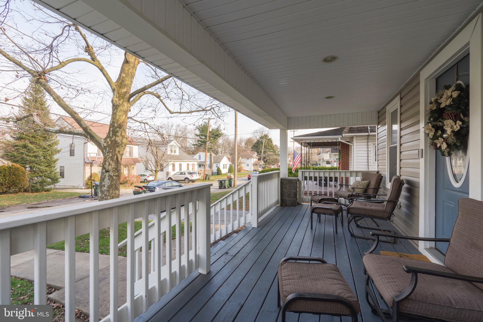 208 Willow Road Wallingford, PA 19086 - Photo 7 of 39 a view of a chairs and table in patio with wooden floor