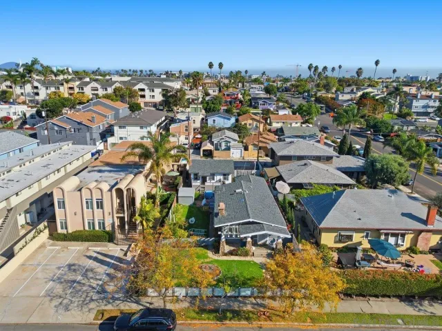 an aerial view of residential houses with city view