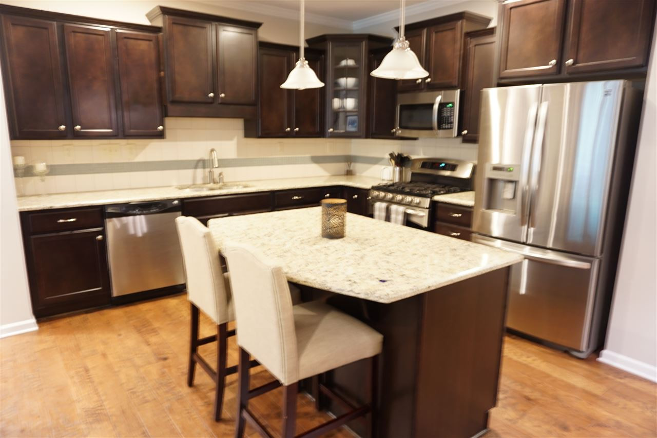 2411 Memory Ridge Drive Raleigh, NC 27606 - Photo 5 of 25 Great open kitchen, with island, SS appliances, built in microwave, gas stove, refrigerator conveys.