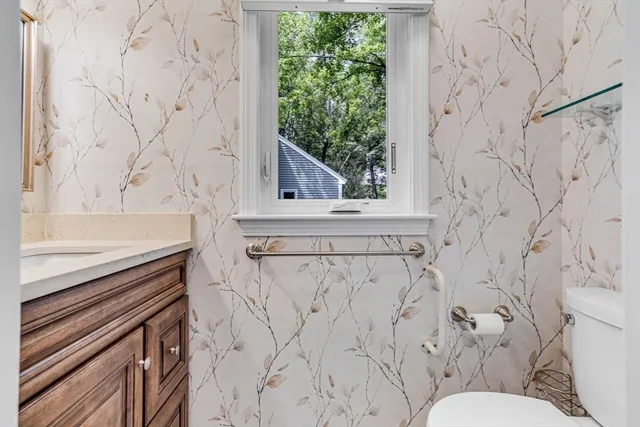 a kitchen with stainless steel appliances granite countertop a refrigerator a stove and a wooden floors