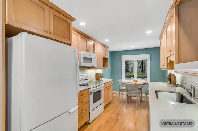 a view of a room with a ceiling fan and a large window