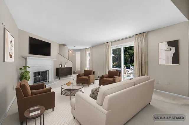 a living room with furniture potted plant and a window