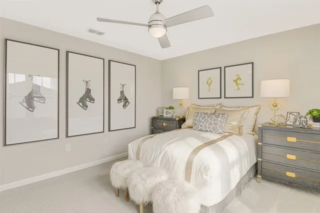 a bedroom with a large bed and a chandelier