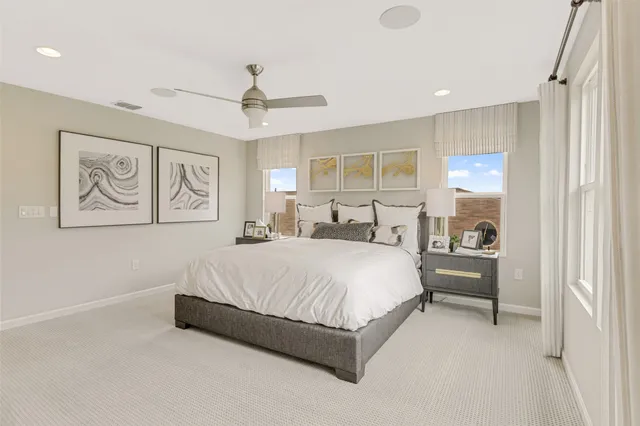 a spacious bedroom with a bed and a painting