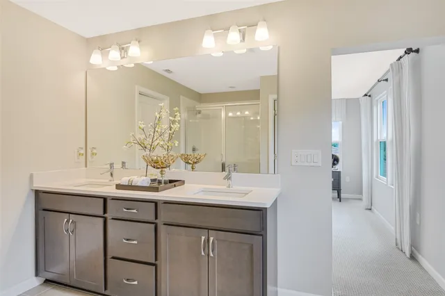 a bathroom with a double vanity sink and a mirror
