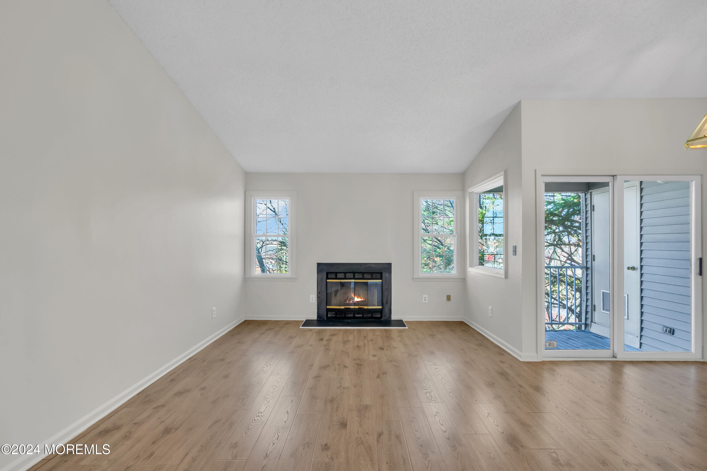 130 Edpas Road, Unit 130 New Brunswick, NJ 08901 - Photo 5 of 16 an empty room with windows and fireplace