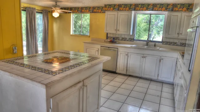 a kitchen with a sink cabinets and window
