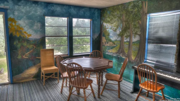 a view of hall way with furniture and wooden floor