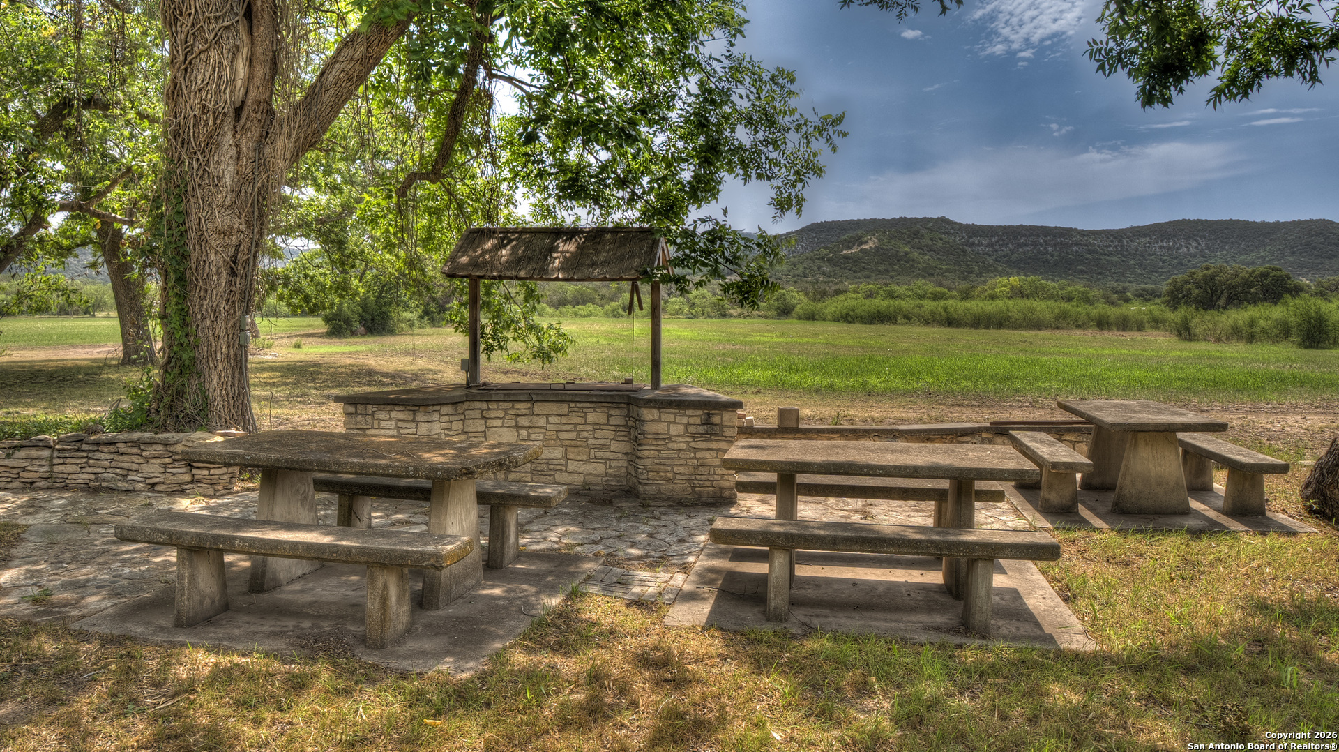 6623 Ranch Road 1120 Rio Frio, TX 78879 - Photo 8 of 25 a view of a lake with a bench and trees