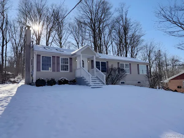 a view of a house with a yard covered in snow