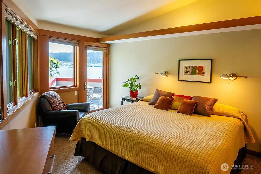 2000 Bayshore Road Lopez Island, WA 98261 - Photo 26 of 40 a bedroom with a bed and glass windows
