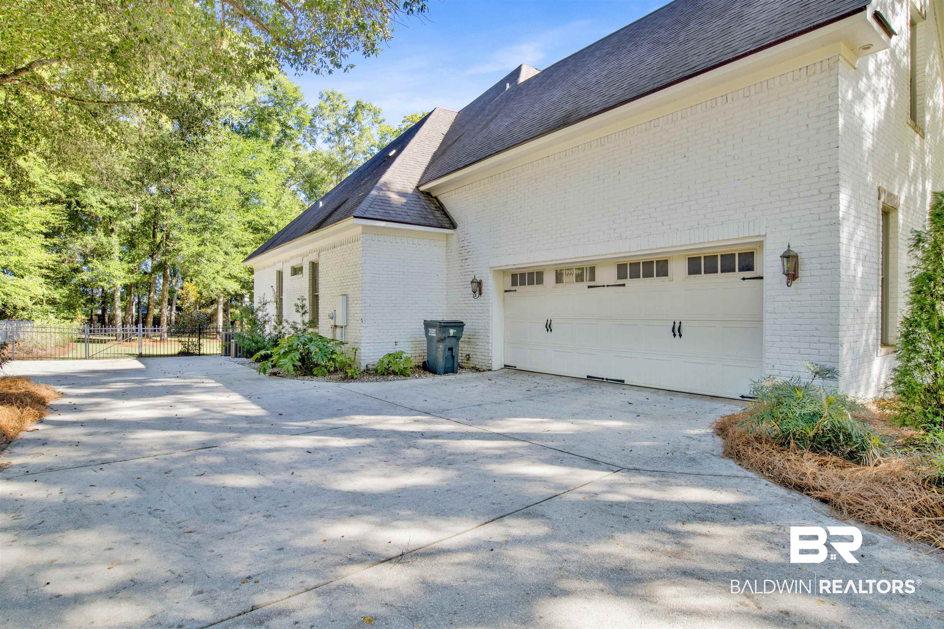 11116 Redfern Road Daphne, AL 36526 - Photo 6 of 46 View of side of property with driveway, brick siding, a shingled roof, and a garage