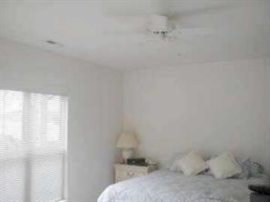 950 Jetton Street, Unit 1 Davidson, NC 28036 - Photo 5 of 8 a bedroom with a bed and a window