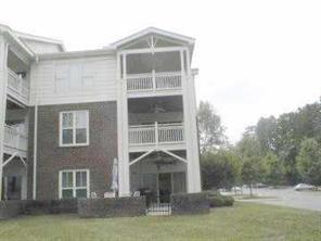 950 Jetton Street, Unit 1 Davidson, NC 28036 - Photo 7 of 8 a front view of a house with a yard