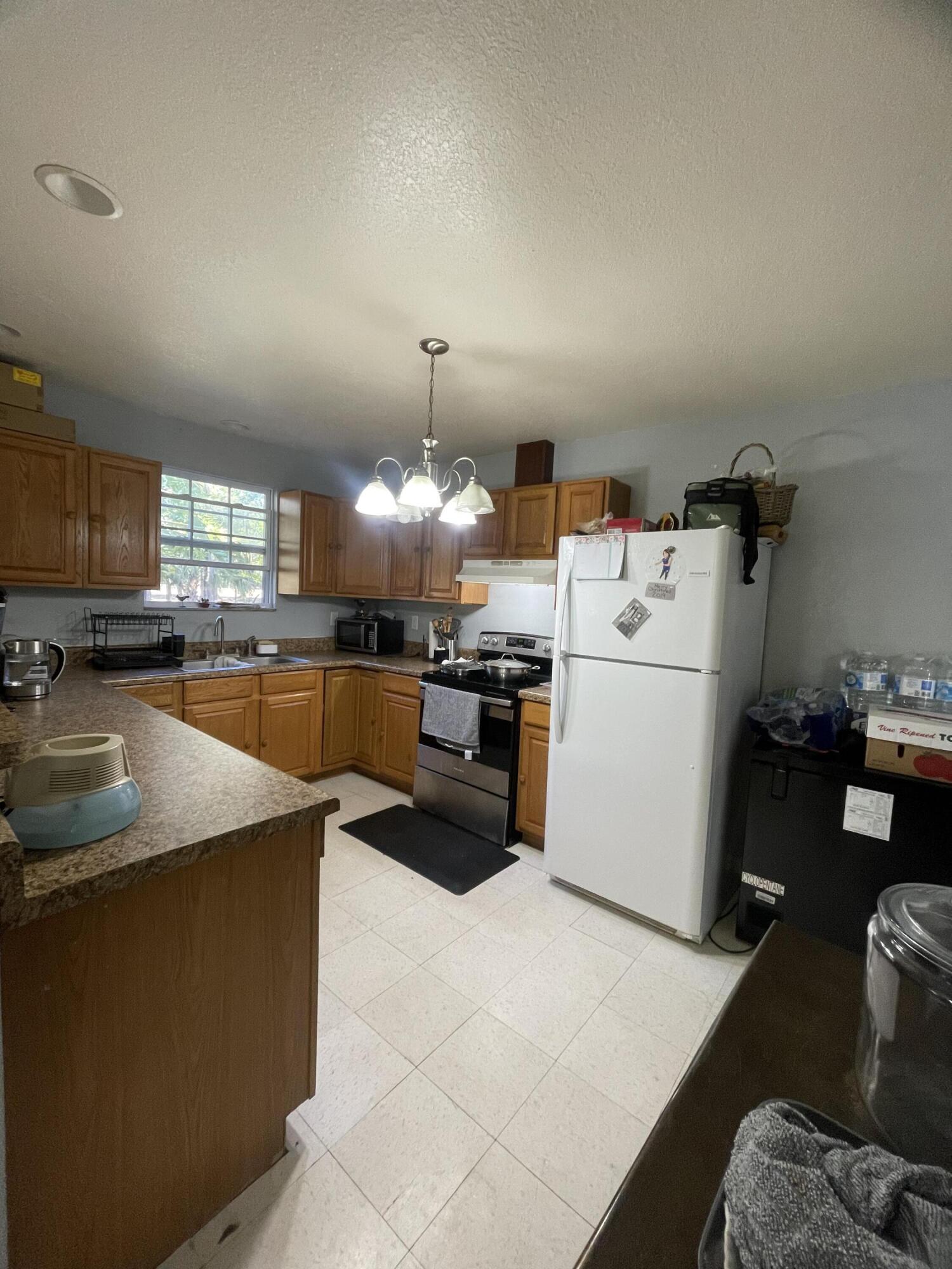 1220 A Road LaBelle, FL 33935 - Photo 16 of 42 a kitchen with furniture a counter top space and stainless steel appliances