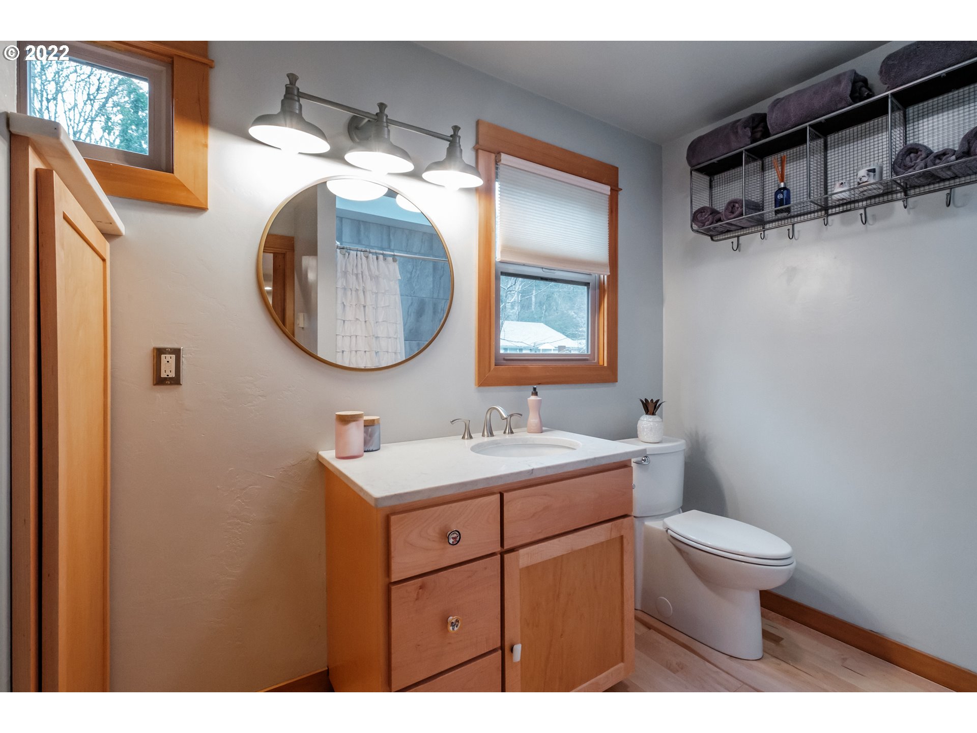 240 West F Street Springfield, OR 97477 - Photo 12 of 32 a bathroom with a toilet sink vanity and mirror