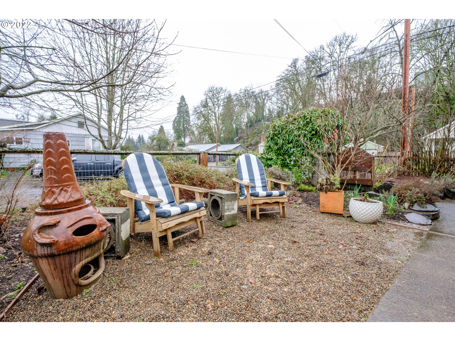 240 West F Street Springfield, OR 97477 - Photo 28 of 32 a view of a backyard with table and chairs potted plants and large tree