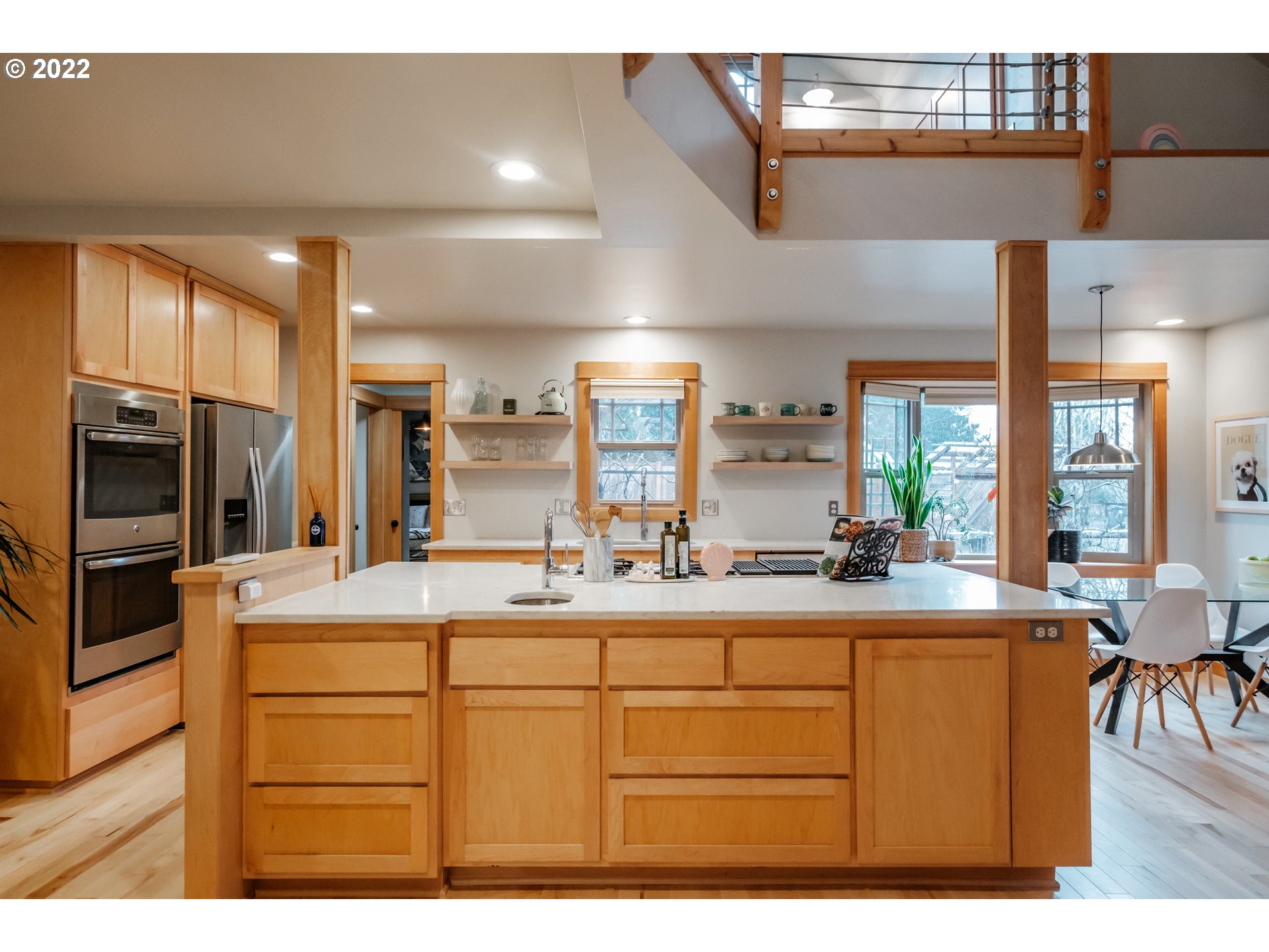 240 West F Street Springfield, OR 97477 - Photo 8 of 32 a kitchen with kitchen island granite countertop a sink and refrigerator