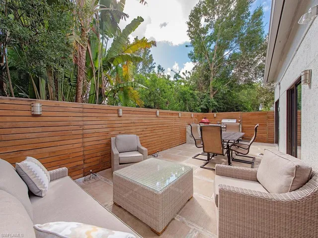 a view of a patio with a table and chairs
