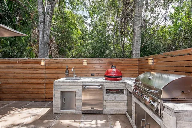 a kitchen with stainless steel appliances a stove and a oven