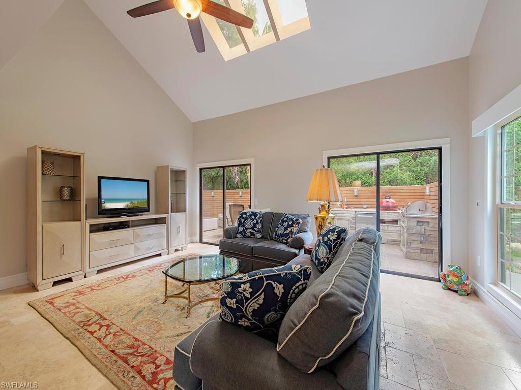 840 Meadowland Drive, Unit H Naples, FL 34108 - Photo 5 of 14 a living room with furniture and a flat screen tv