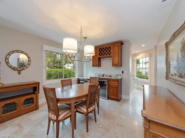 a view of a dining room with furniture and a chandelier