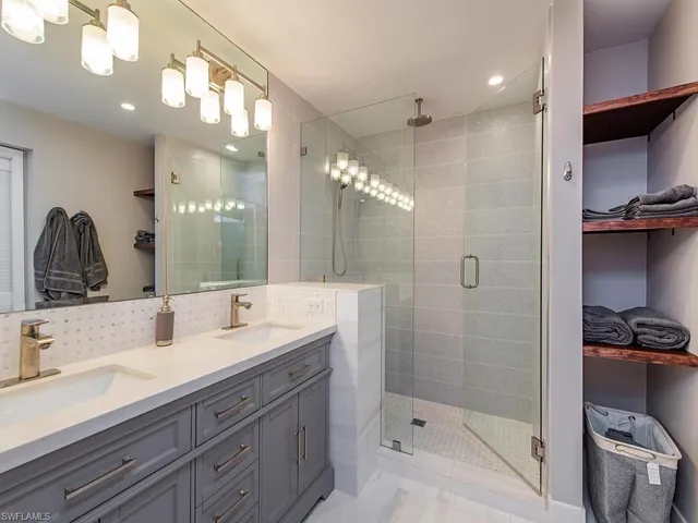 a bathroom with a double vanity sink and mirror