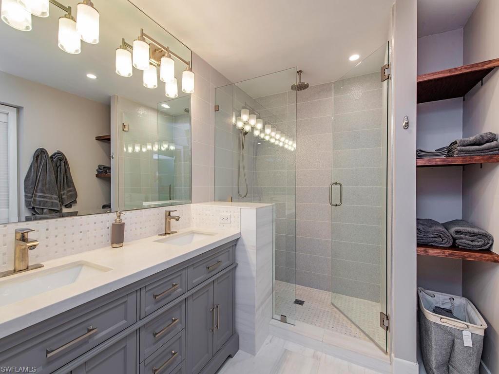 840 Meadowland Drive, Unit H Naples, FL 34108 - Photo 10 of 14 a bathroom with a double vanity sink and mirror