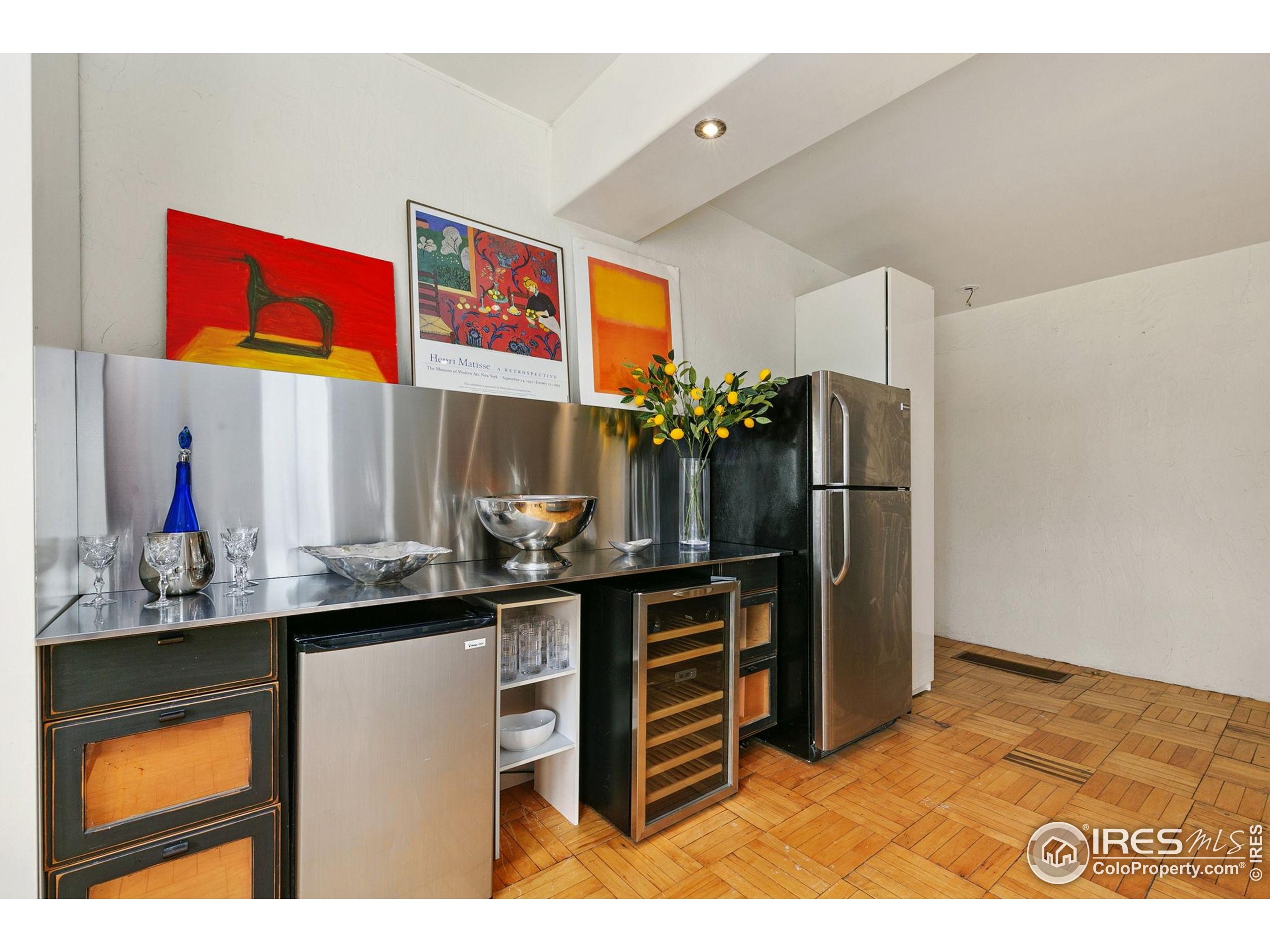 1304 West Prospect Road Fort Collins, CO 80526 - Photo 11 of 29 a kitchen with stainless steel appliances kitchen island granite countertop a refrigerator and a sink