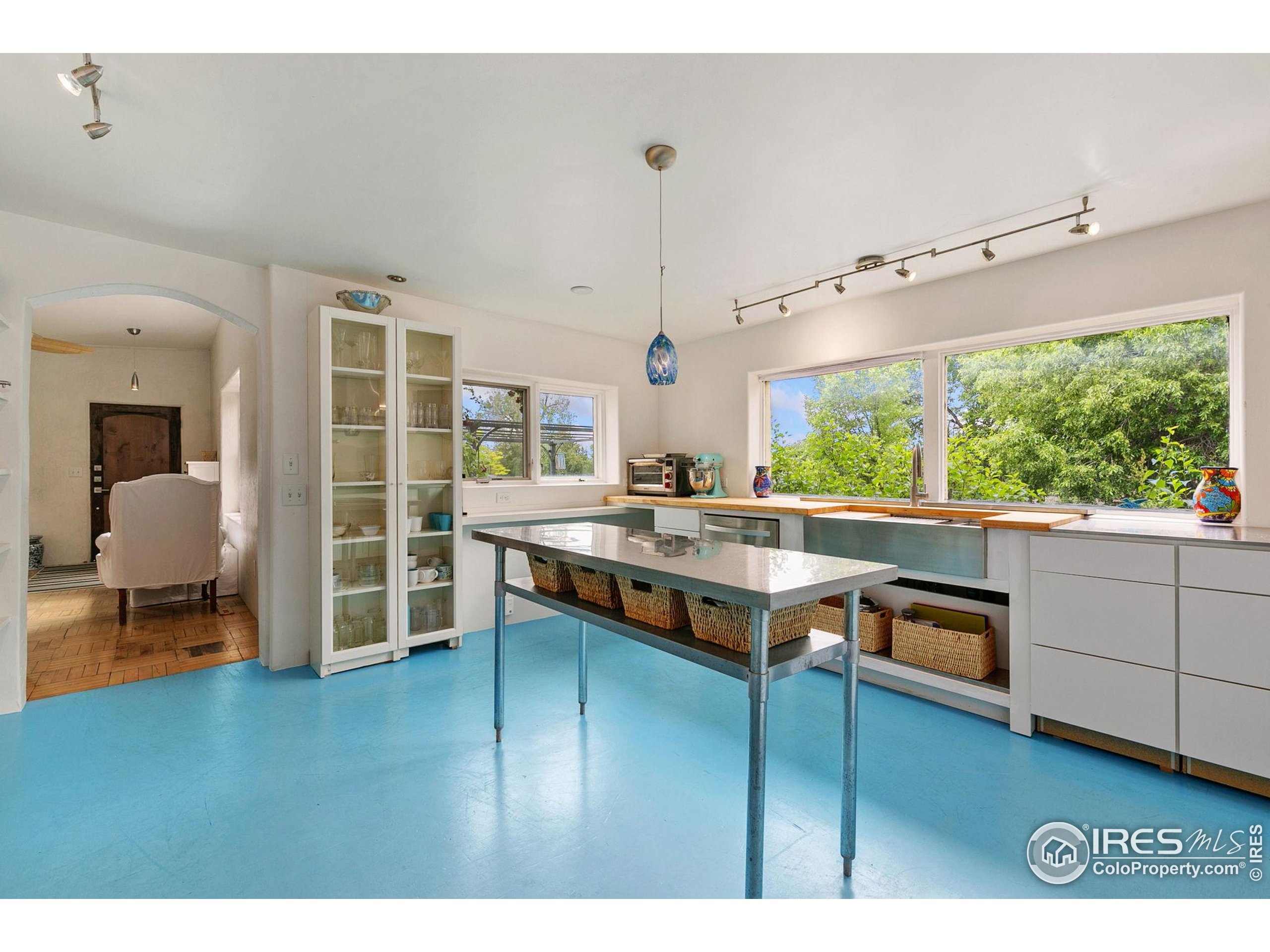 1304 West Prospect Road Fort Collins, CO 80526 - Photo 15 of 29 a kitchen with stainless steel appliances granite countertop a stove and a view of living room