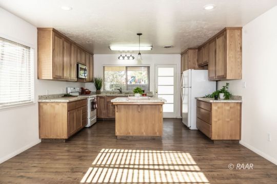 437 Peg Street Ridgecrest, CA 93555 - Photo 2 of 35 a kitchen with stainless steel appliances a stove a sink cabinets and a window
