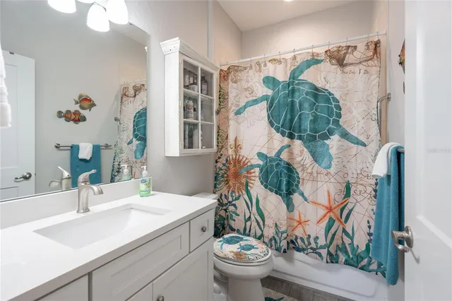 a bathroom with a sink mirror and toilet