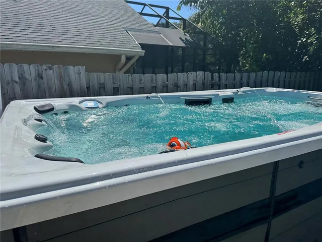 a view of backyard with wooden fence