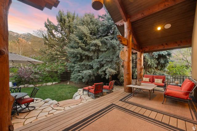 10280 Dimple Dell Road Sandy, UT 84092 - Photo 18 of 58 Wooden deck with a patio, an outdoor hangout area, and a fenced backyard