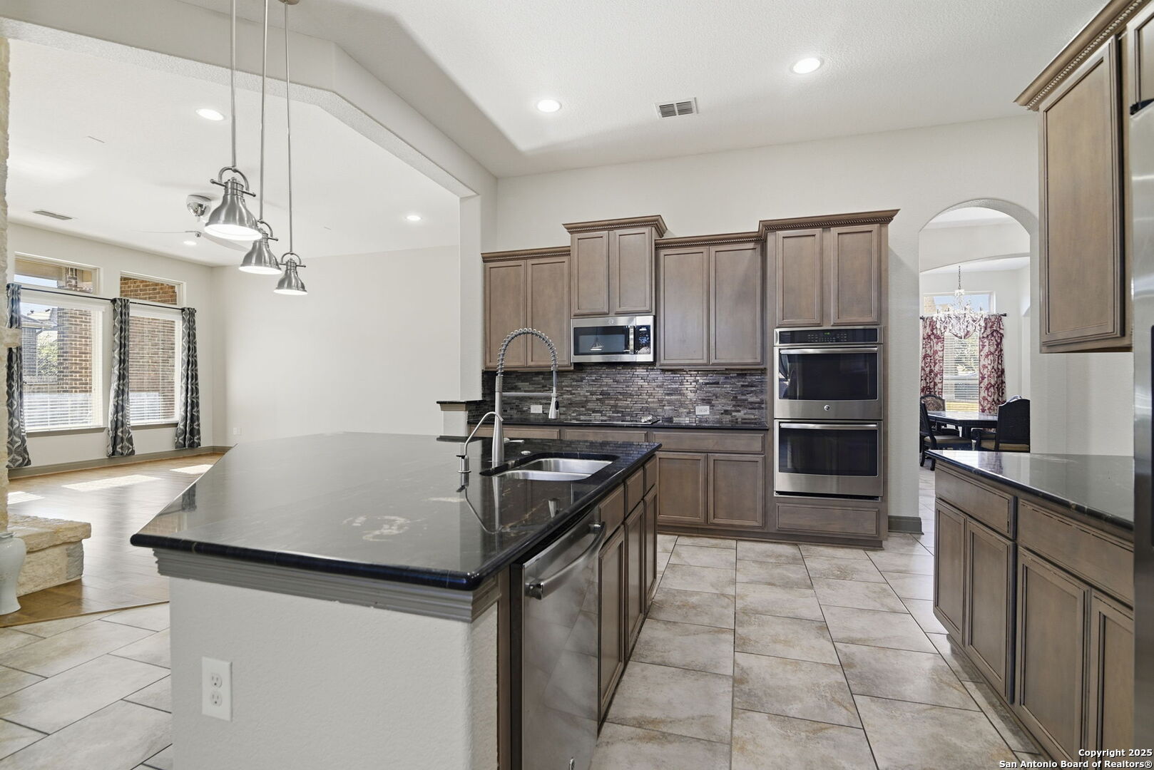 904 Turning Stone Cibolo, TX 78108 - Photo 11 of 35 a kitchen with stainless steel appliances granite countertop a sink refrigerator and cabinets
