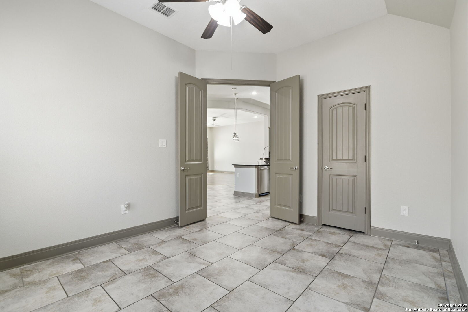 904 Turning Stone Cibolo, TX 78108 - Photo 13 of 35 en empty room with a fireplace and a chandelier fan