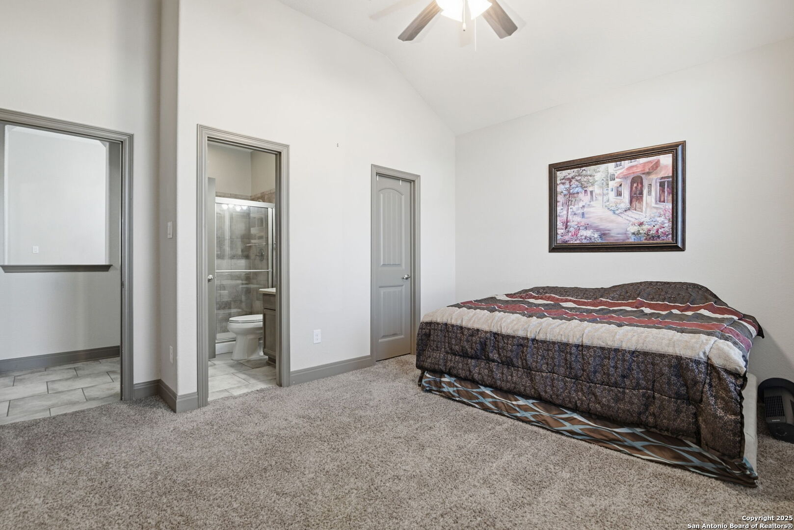 904 Turning Stone Cibolo, TX 78108 - Photo 21 of 35 a spacious bedroom with a bed and a chandelier