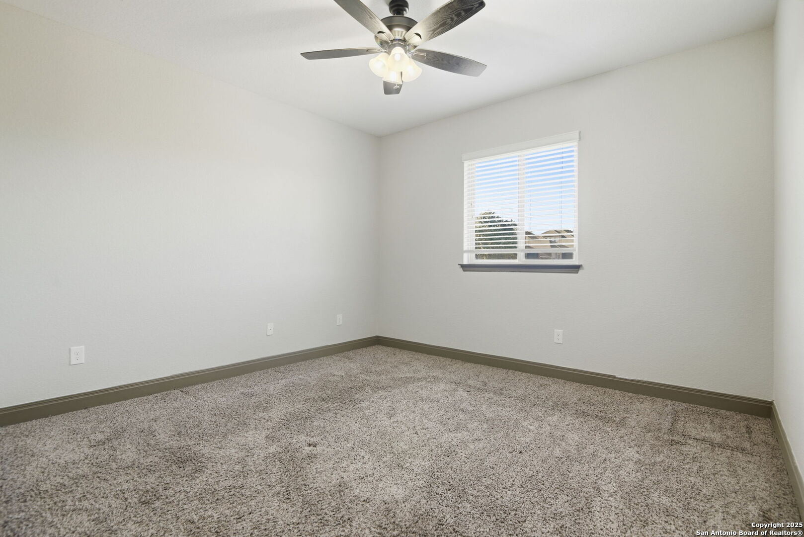 904 Turning Stone Cibolo, TX 78108 - Photo 23 of 35 an empty room with a window and a ceiling fan