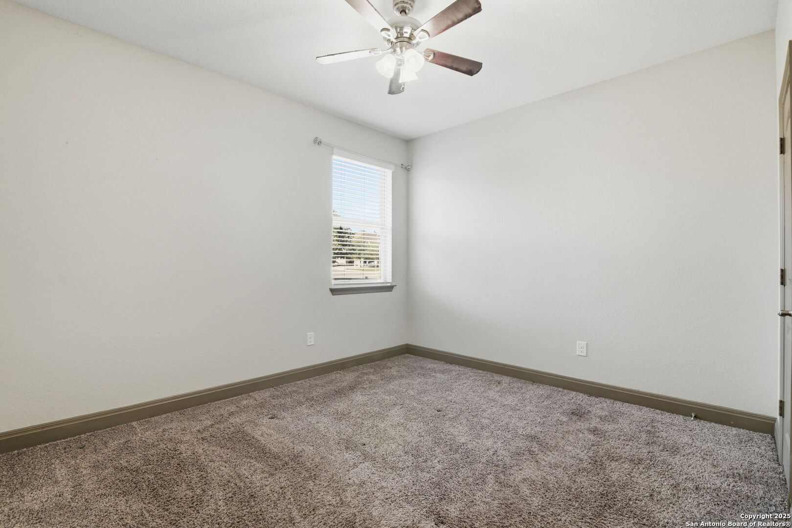 904 Turning Stone Cibolo, TX 78108 - Photo 27 of 35 an empty room with a window and a fan